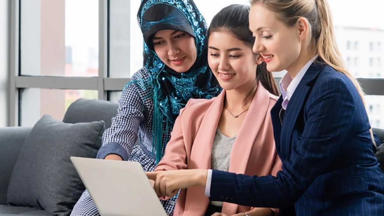 Three Students Looking at Laptop