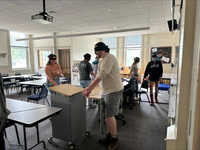 blindfolded students walk around room