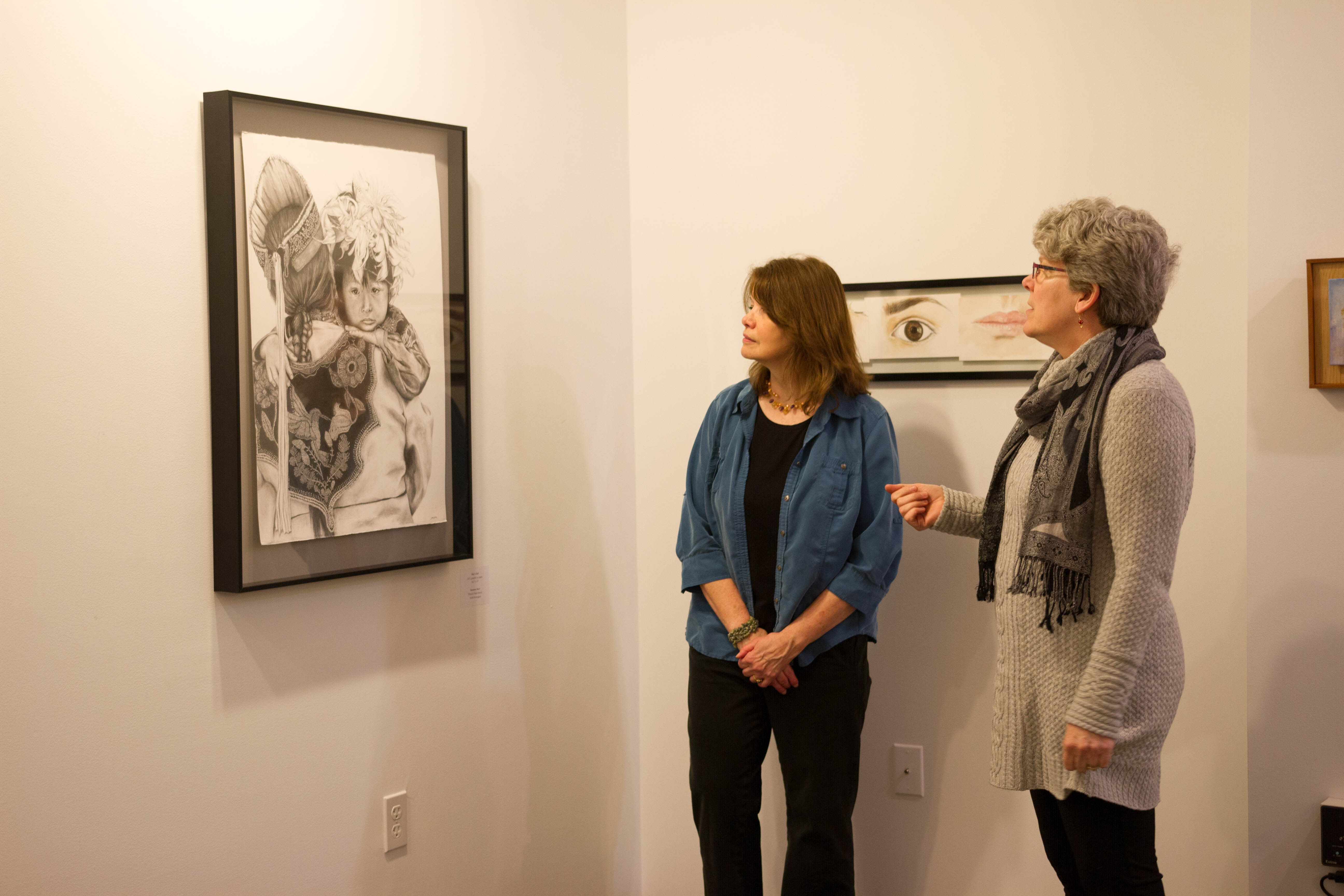 women look at artwork in Pegasus gallery