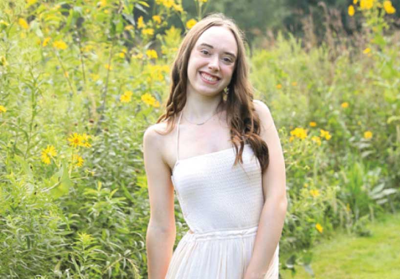 Ella Gannon in field of wildflowers