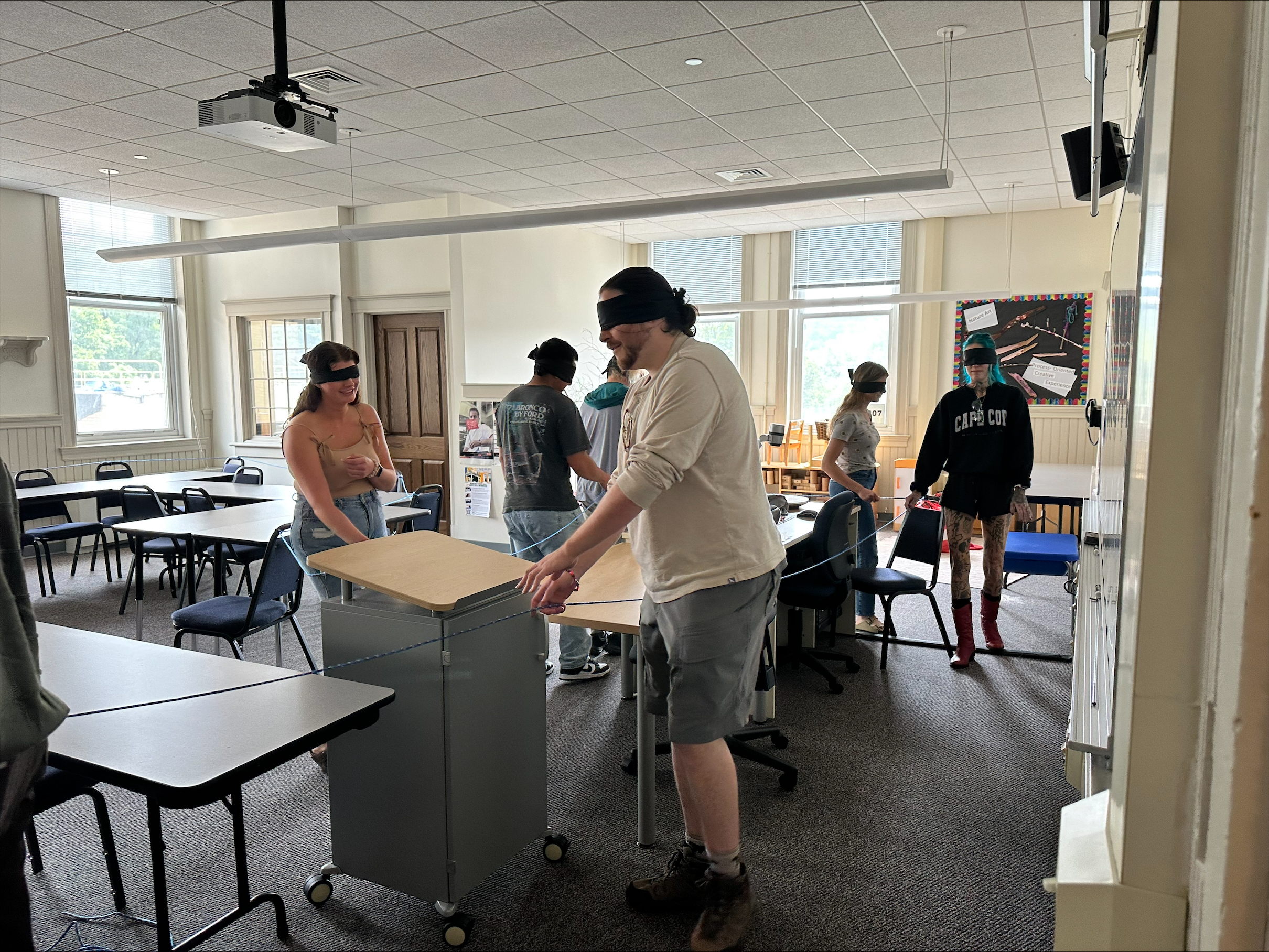 blindfolded students walk around room