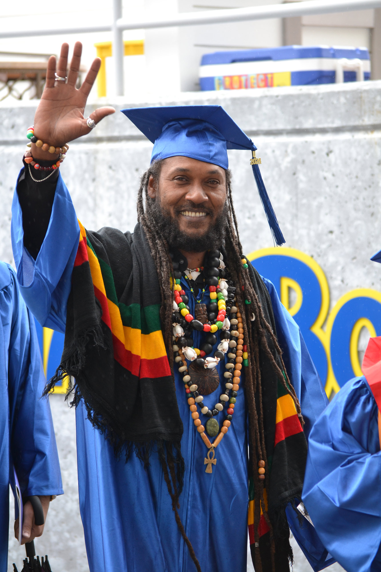 graduated, drapped in robes and beaded necklaces waves