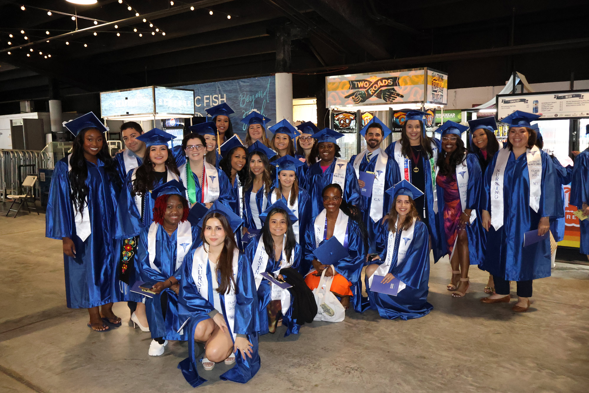 large group of graduates pose before ceremony