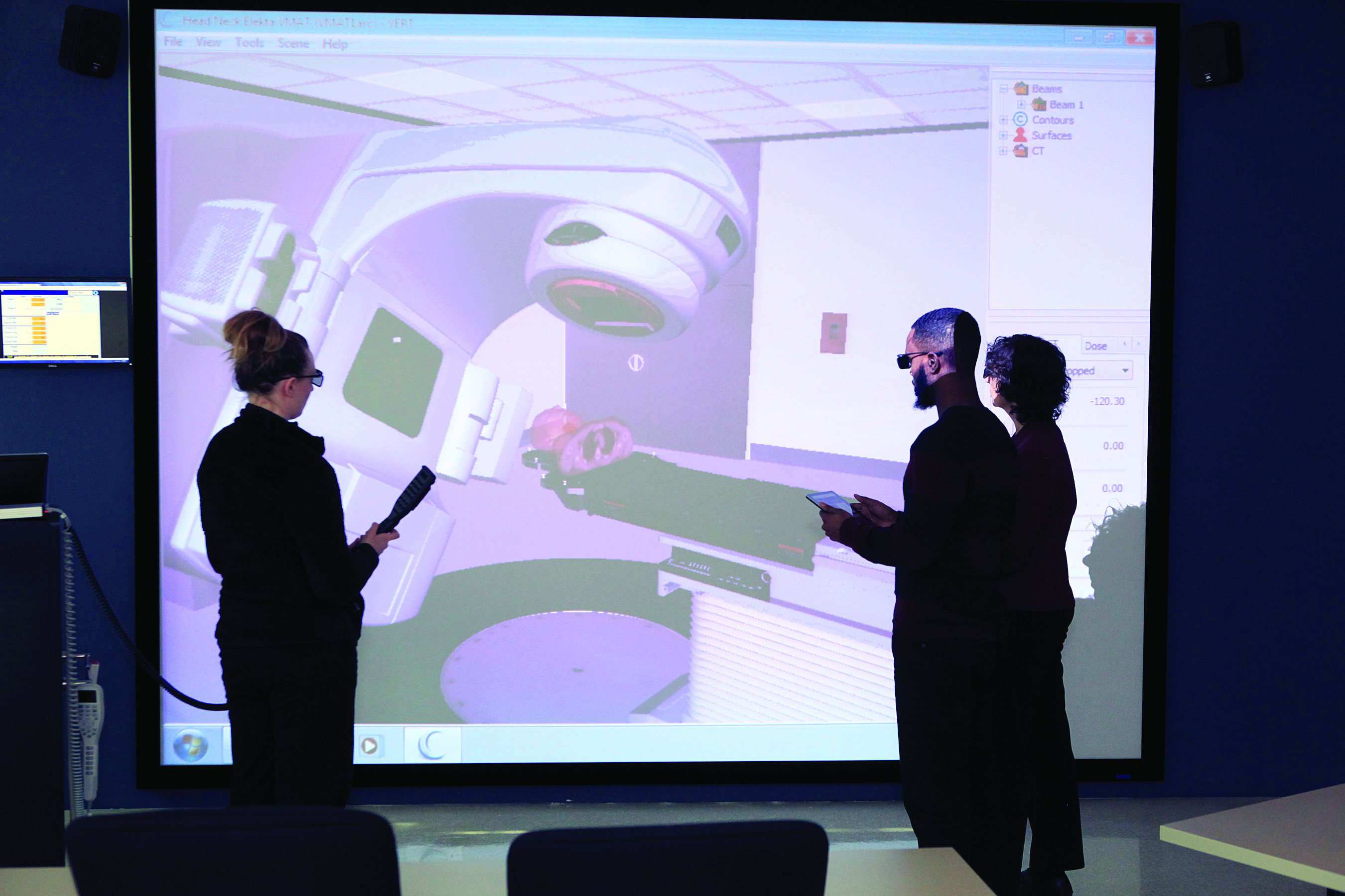 radiation therapy students look at image on screen