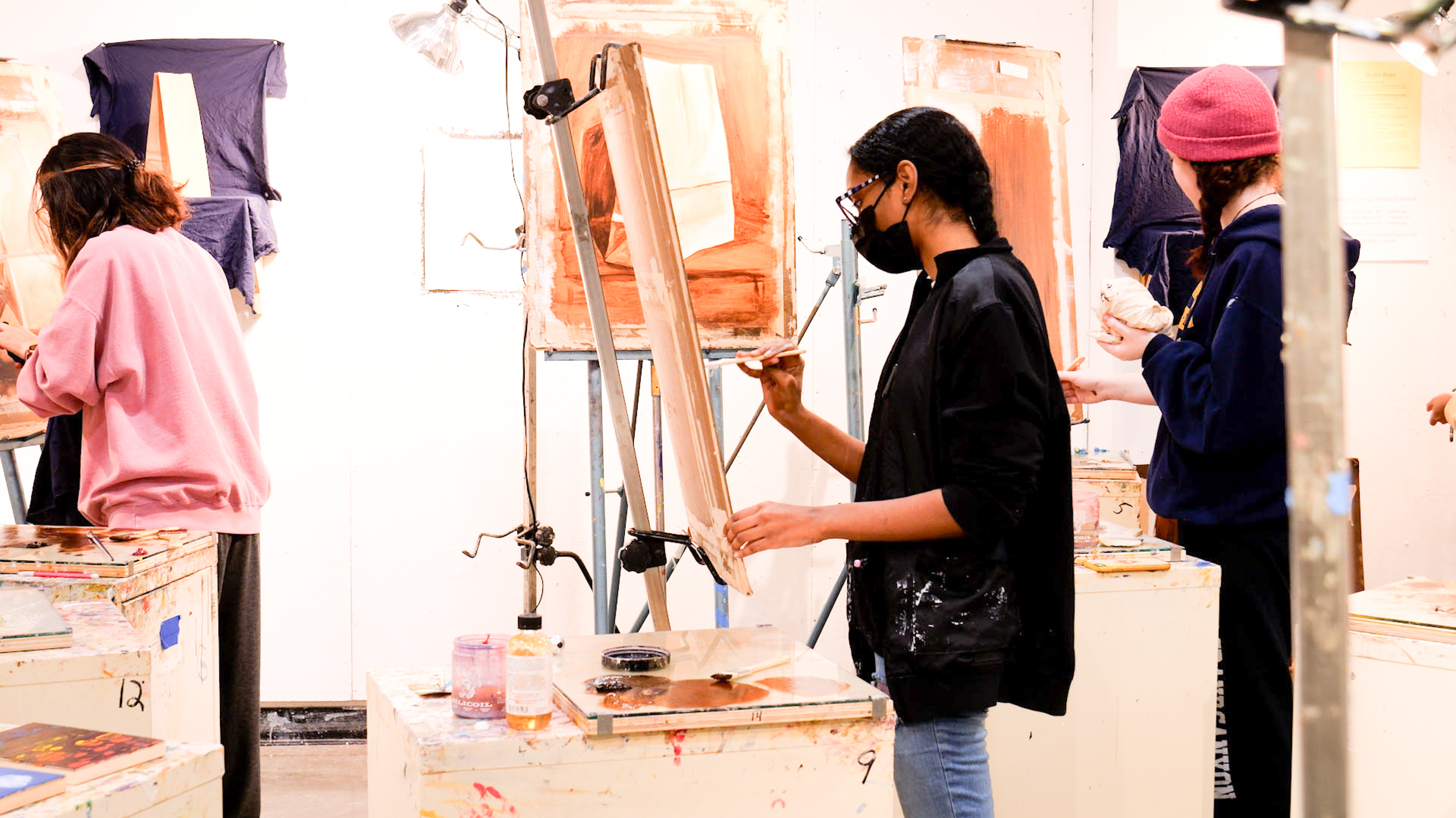 art students paint in studio class