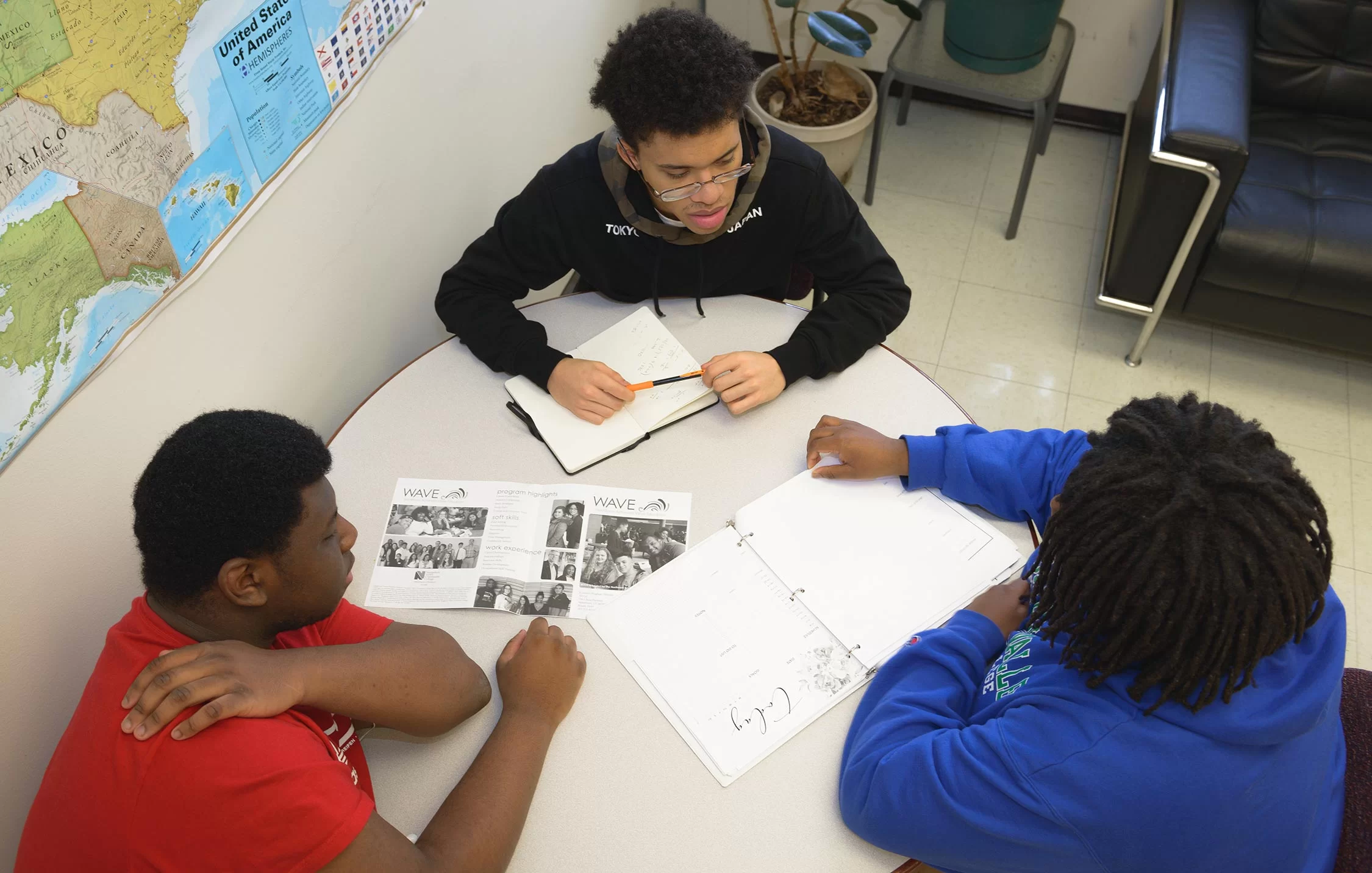 students work together at table on project