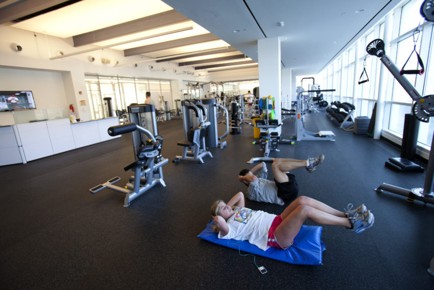 fitness center with people working out in it