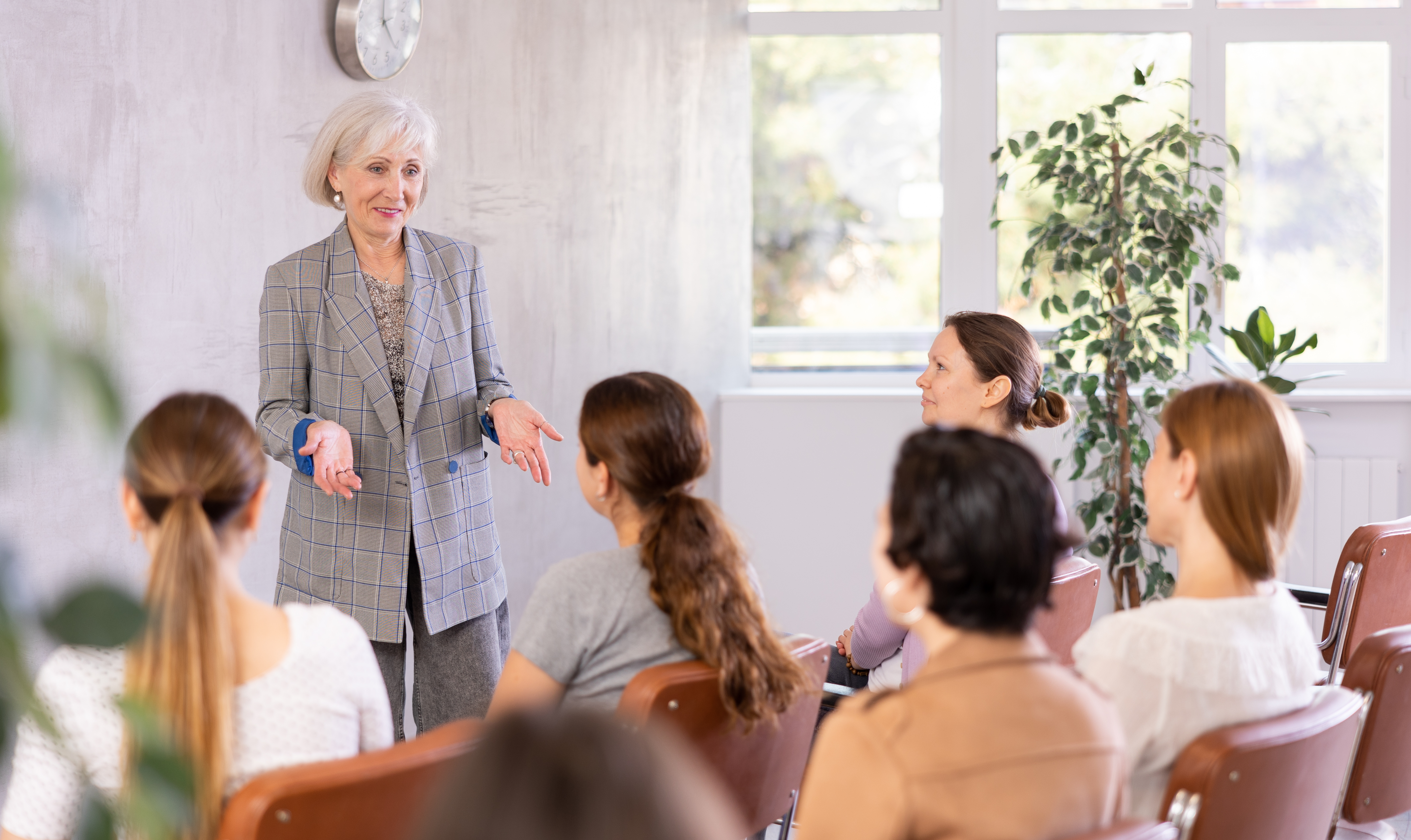 Business woman speaks in front of group of women