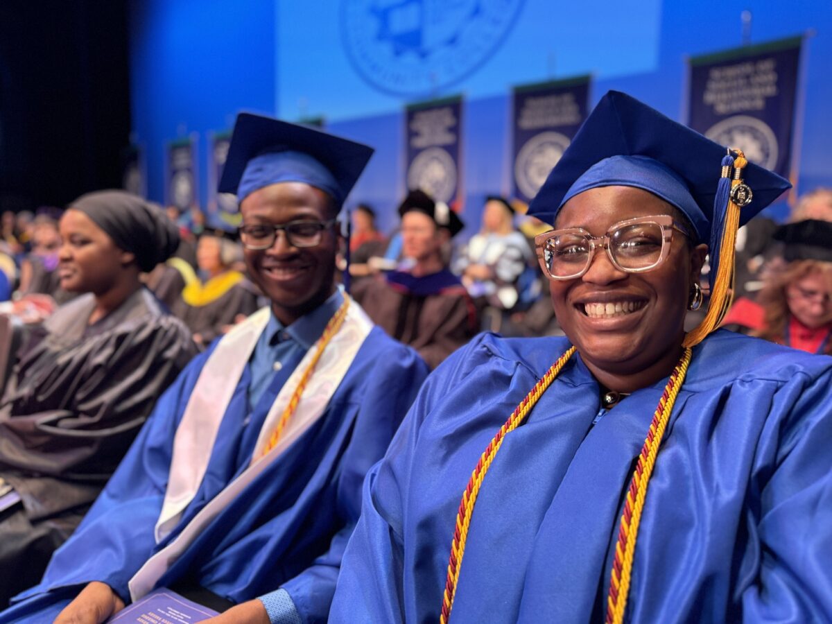 smiling graduates at commencement ceremony