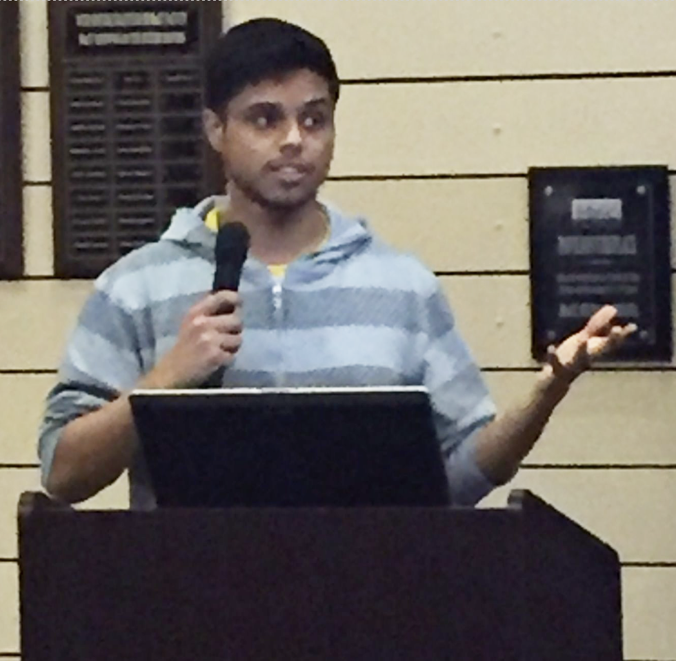 Mukshud Ahamed speaks at podium during academic convivium