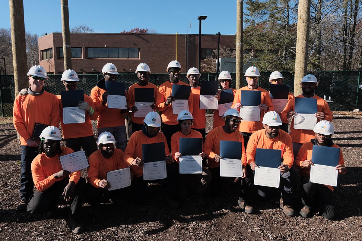 Overhead lineworker graduates pose with certificates