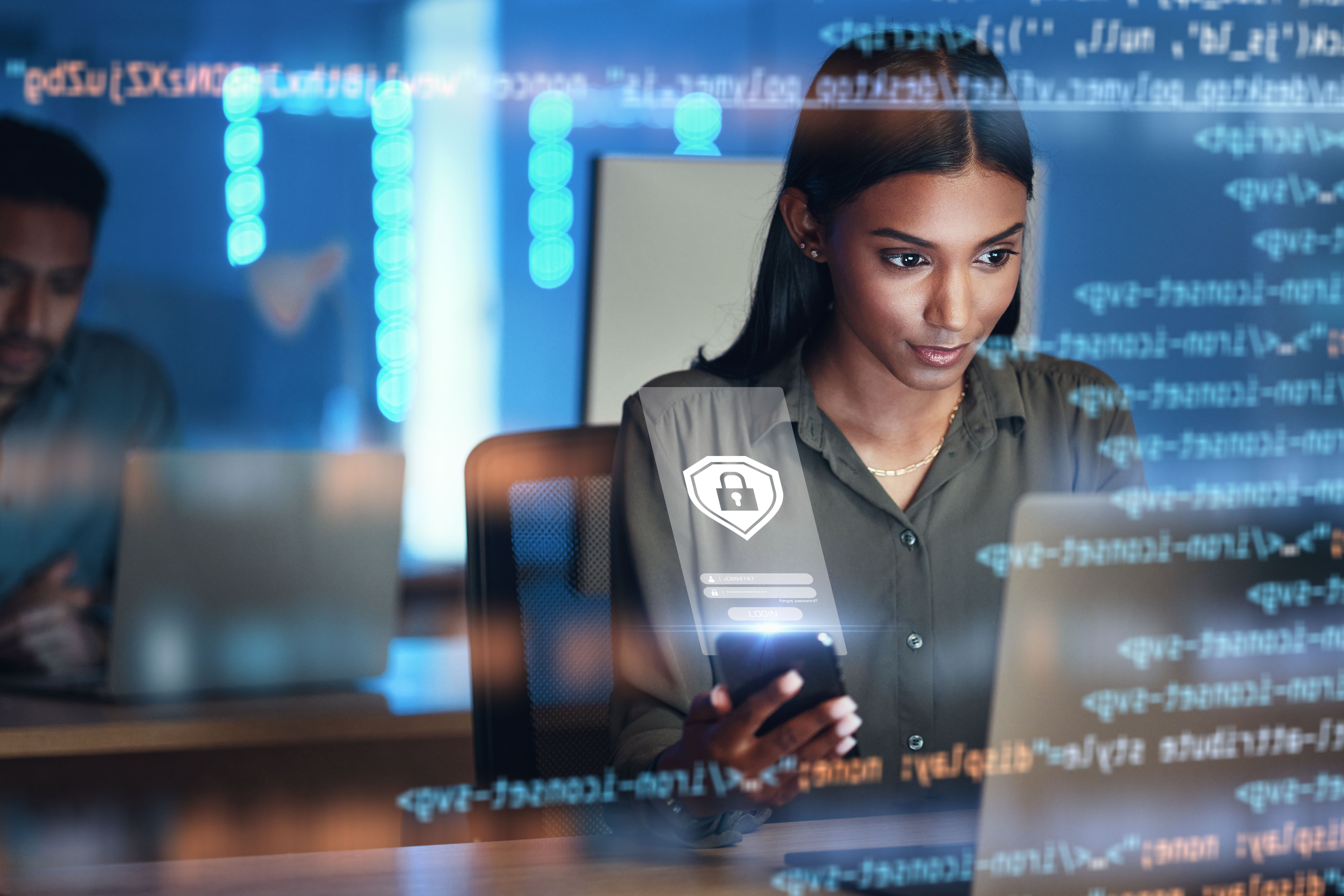 Person looking at computer screen with code in front of image.