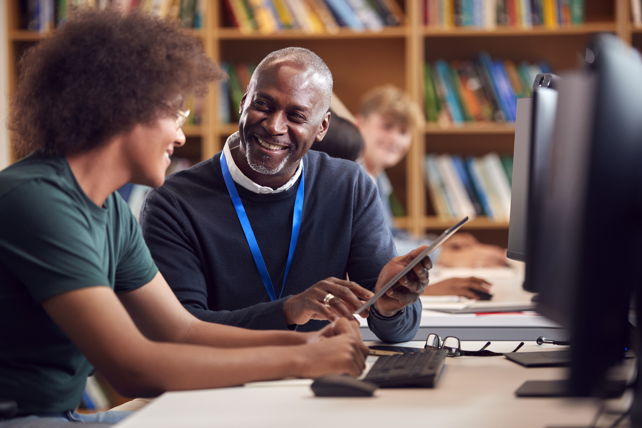 Tutor helps student in computer lab