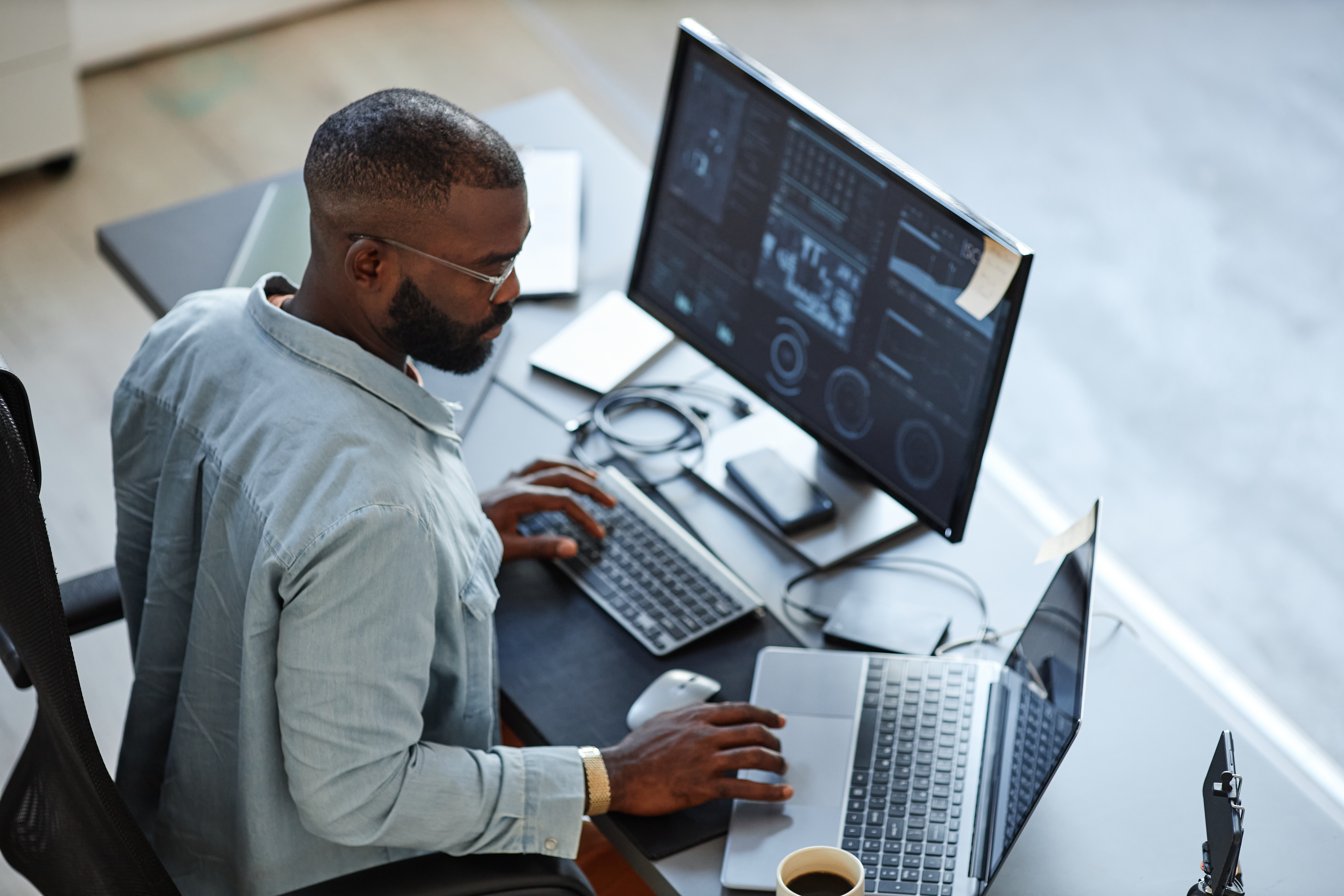Person looking at computer screen with code in front of image.