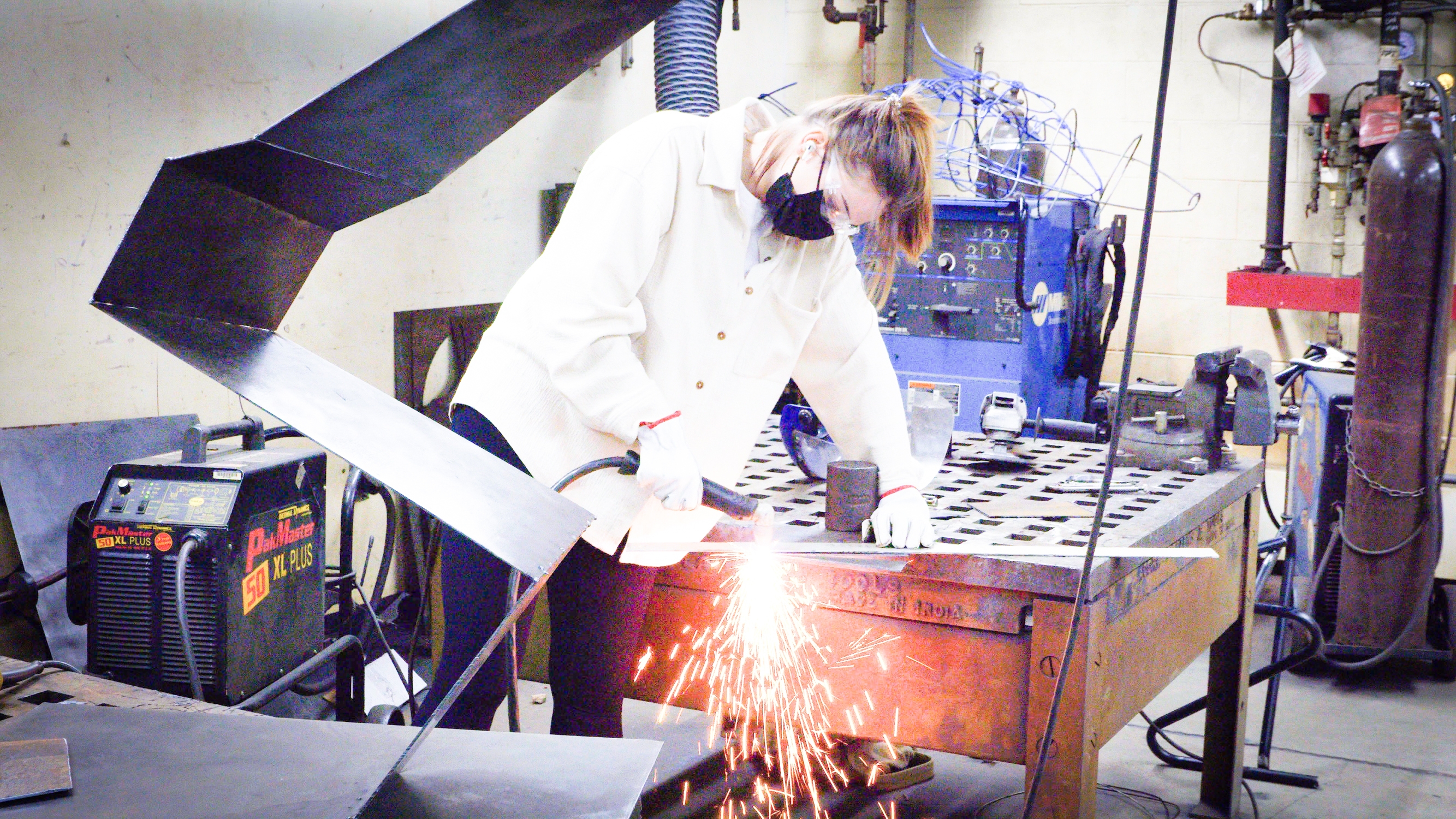 MCC. MS. Student Meassuring And Cutting Metal