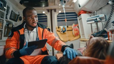 EMT talks to patient in ambulance