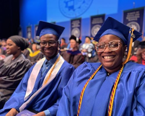 smiling graduates at commencement ceremony