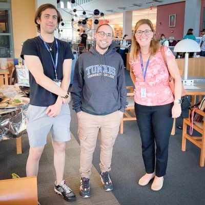 group of three people at Tunxis smile together