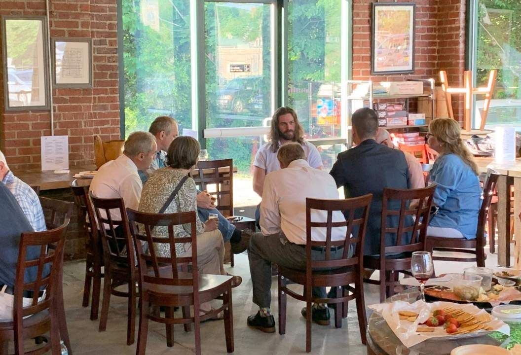 group in coffee shot meets around table