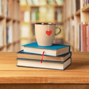 mug on top of books in library