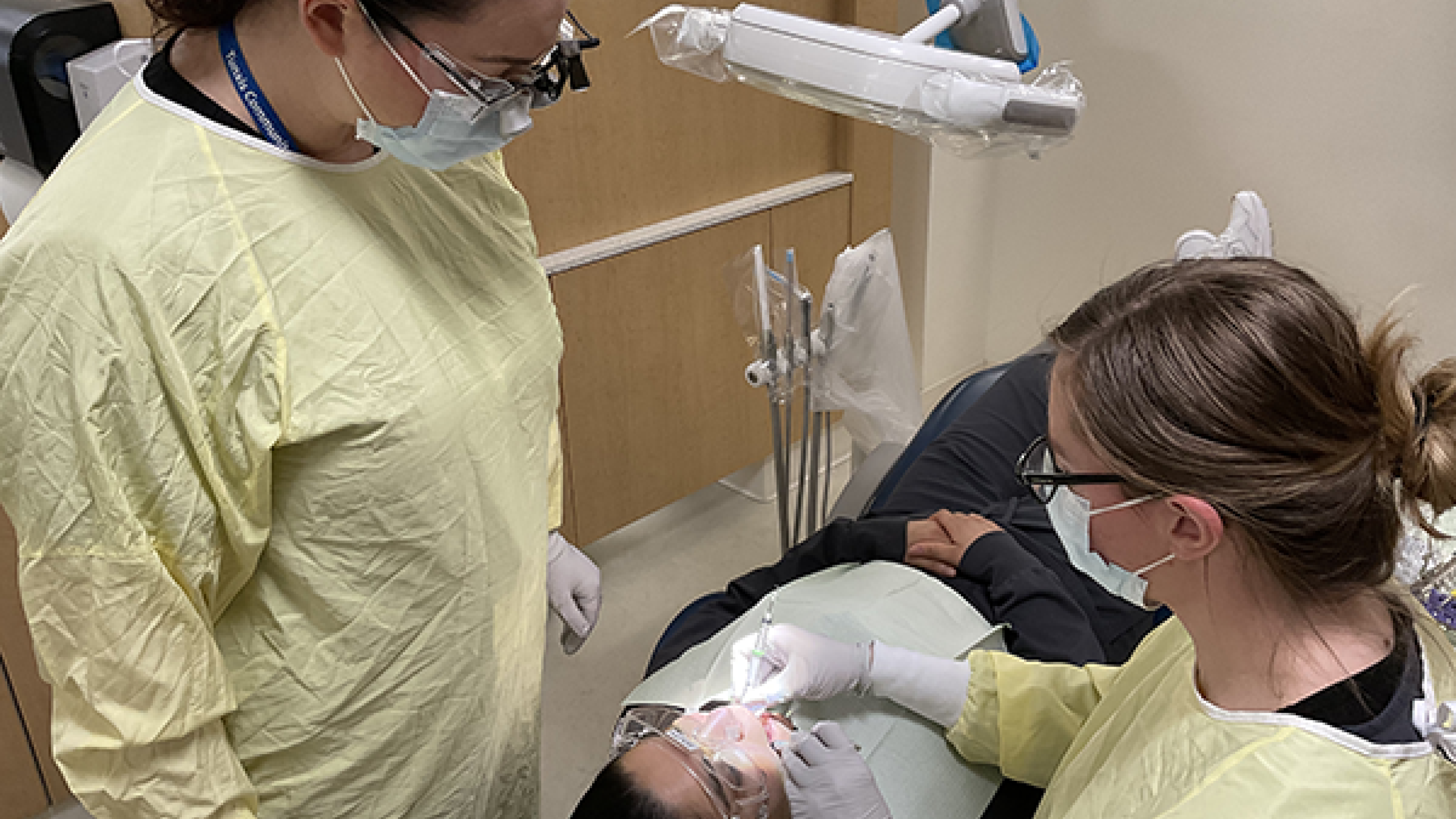 Dental hygiene students look at a dental x-ray together