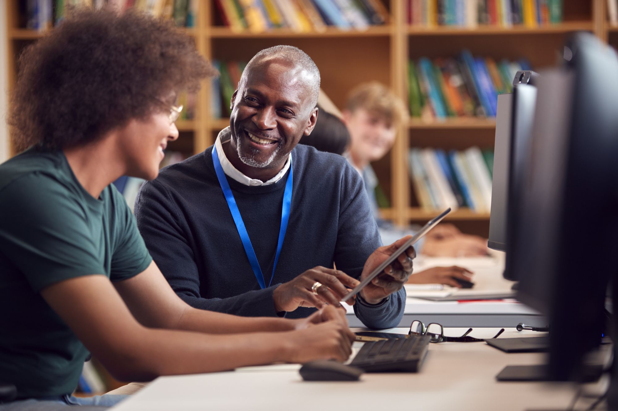 Tutor helps student in computer lab
