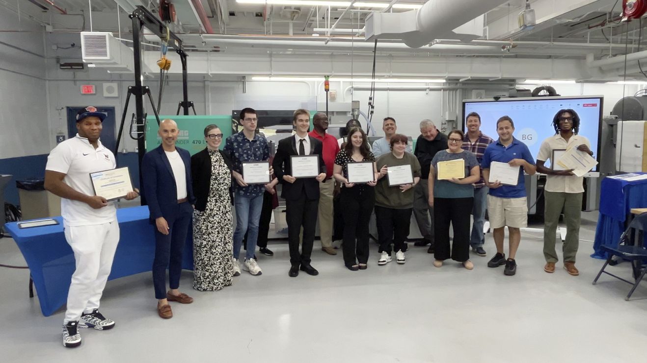 Students cpictured holding awards for completion of Skill Up for Manufacturing training program