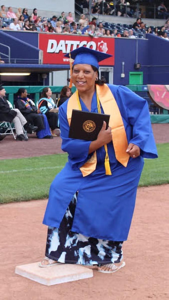 A graduate poses during the commencement ceremony.