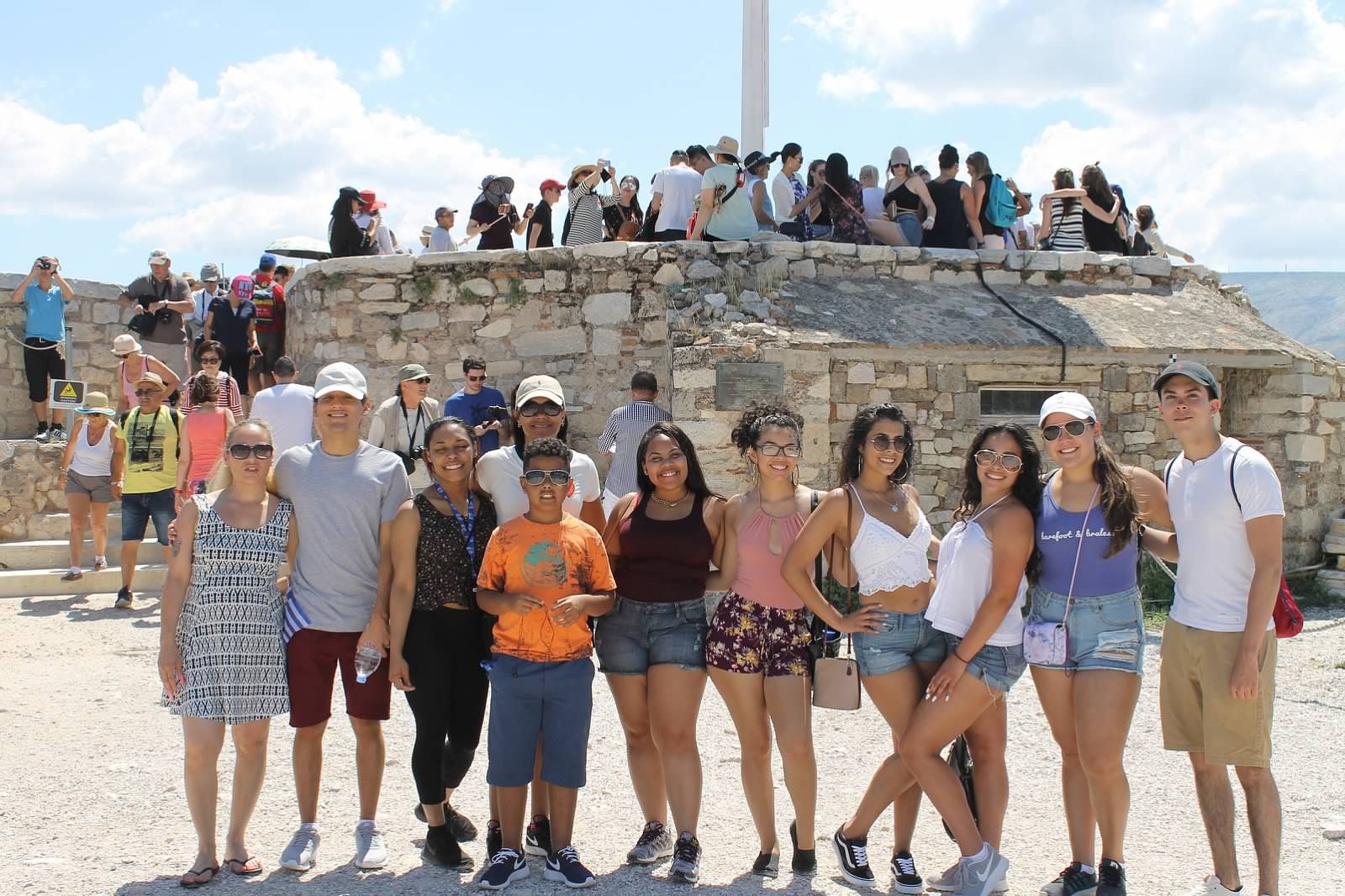 group of student pose in front of monument