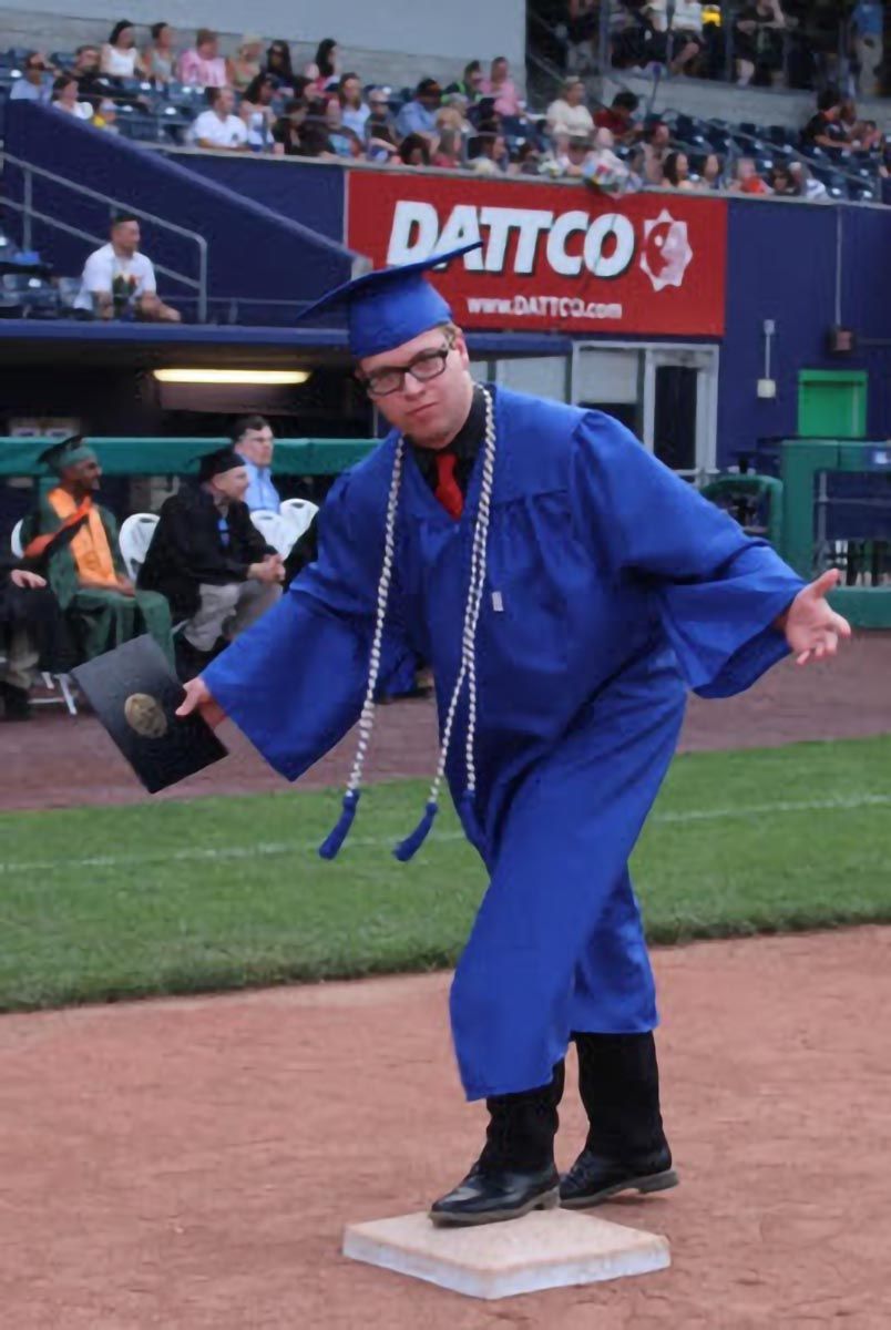 A graduate poses during the commencement ceremony.
