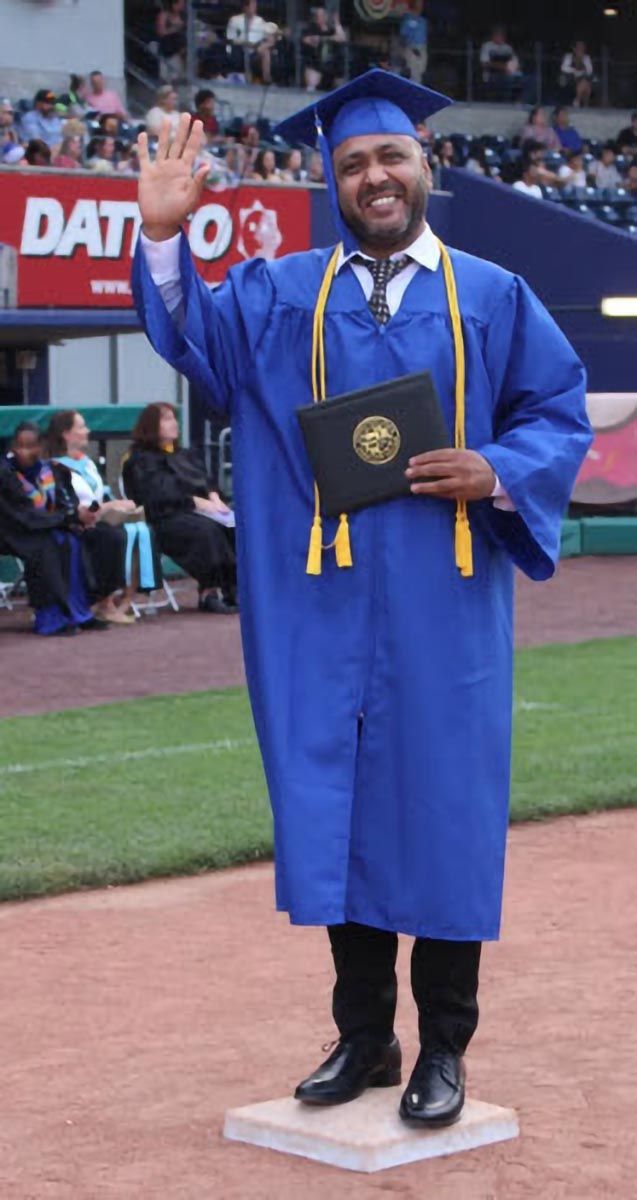 A graduate poses during the commencement ceremony.