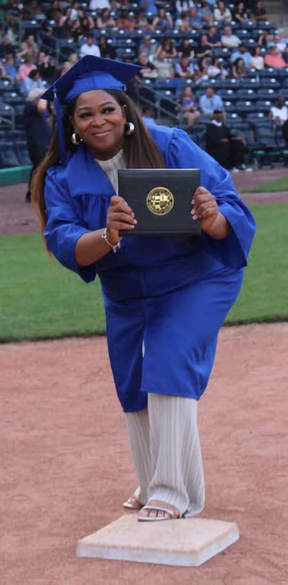 A graduate poses during the commencement ceremony.