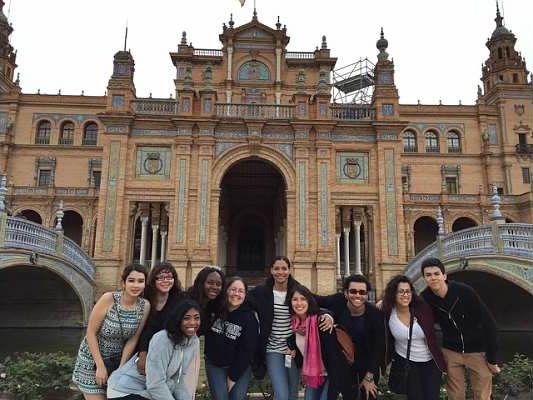 group of students pose in front of castle