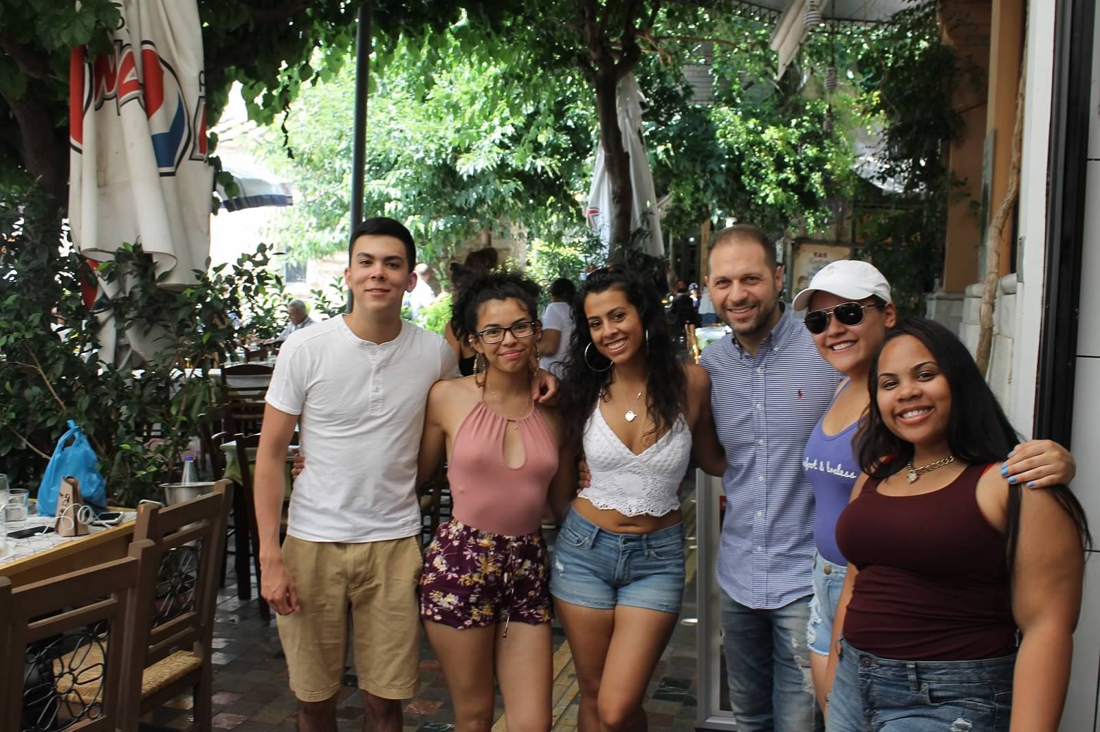 students pose at restaurant