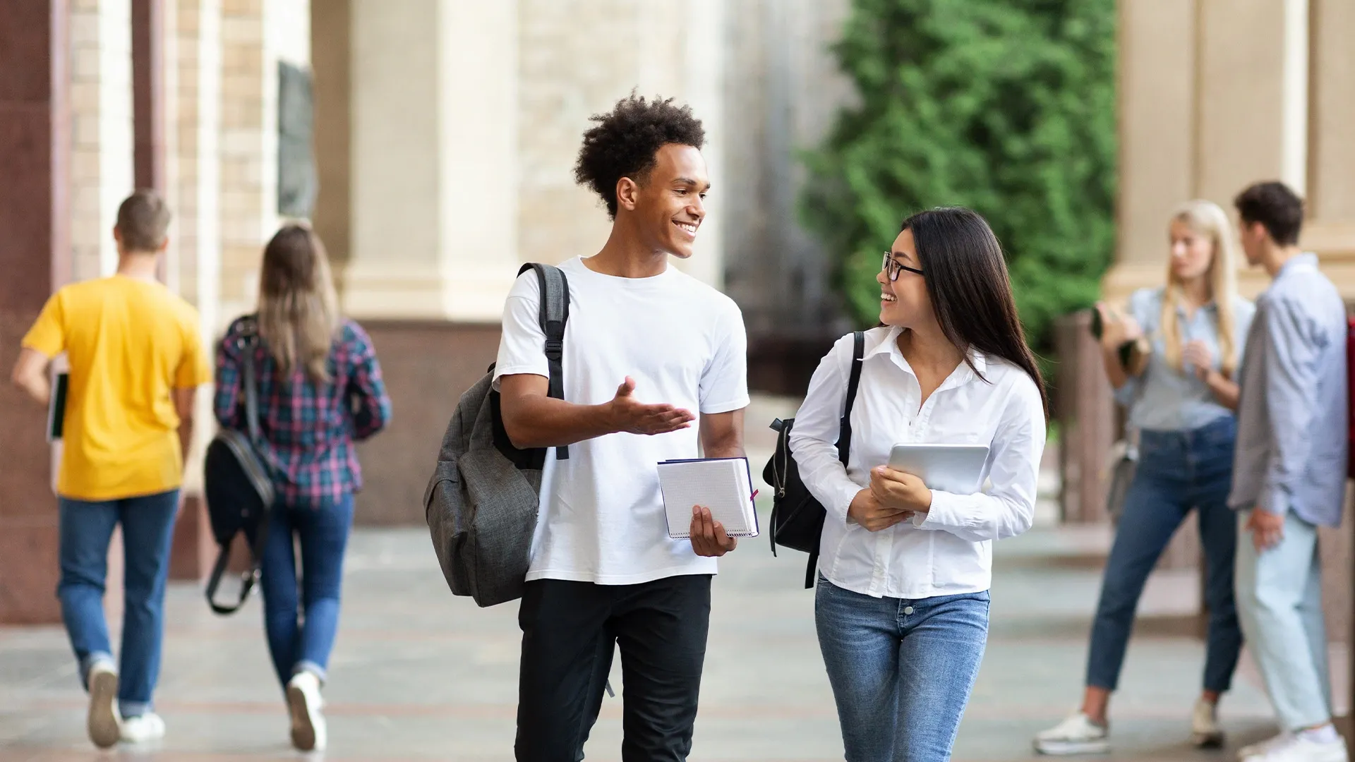 student walk and talk together between classes