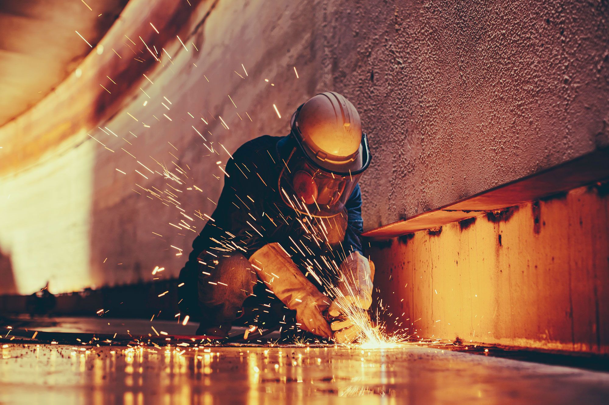 woman welds in tunnel