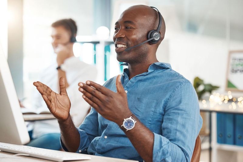 IT support tech smiles and talks on headpiece