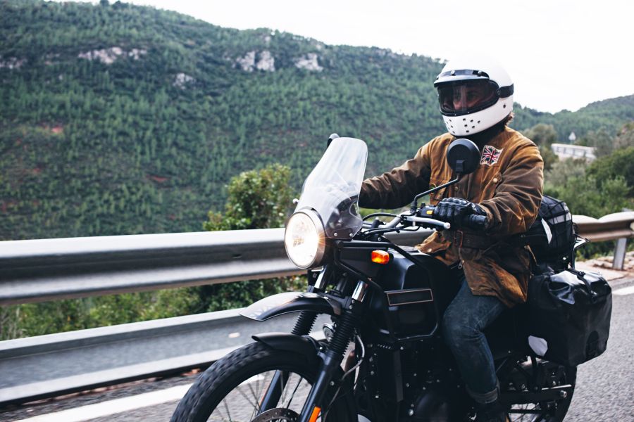 rider on motorcycle drives in front of mountain