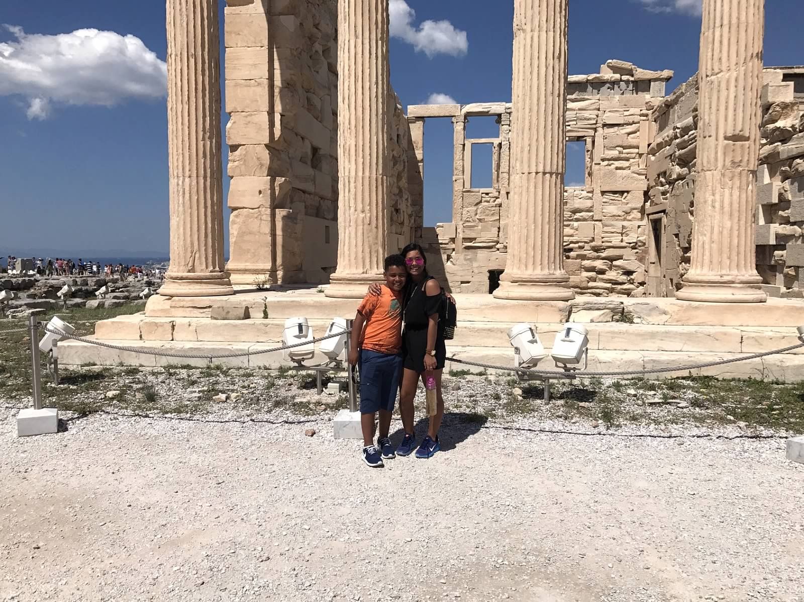 students pose in front of monument