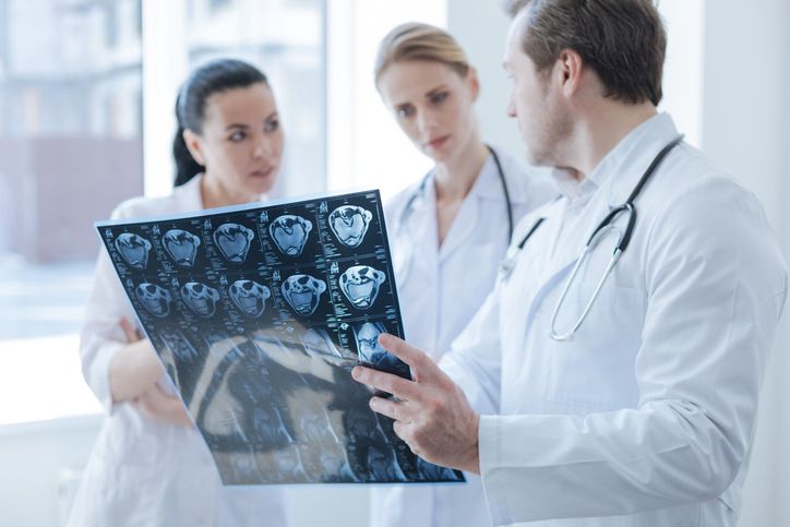 medical professionals look at scan chart