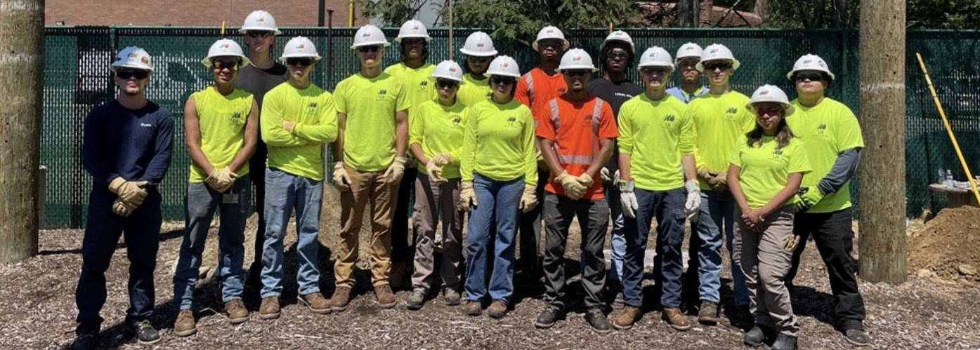 cohort of line worker class pose together.