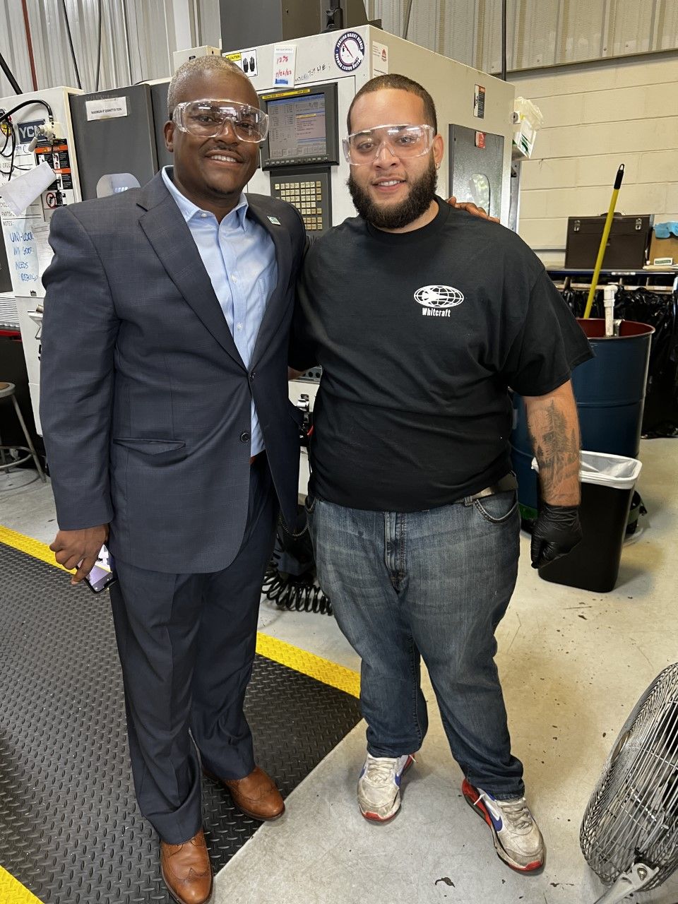 Duncan Harris stands with student in manufacturing lab