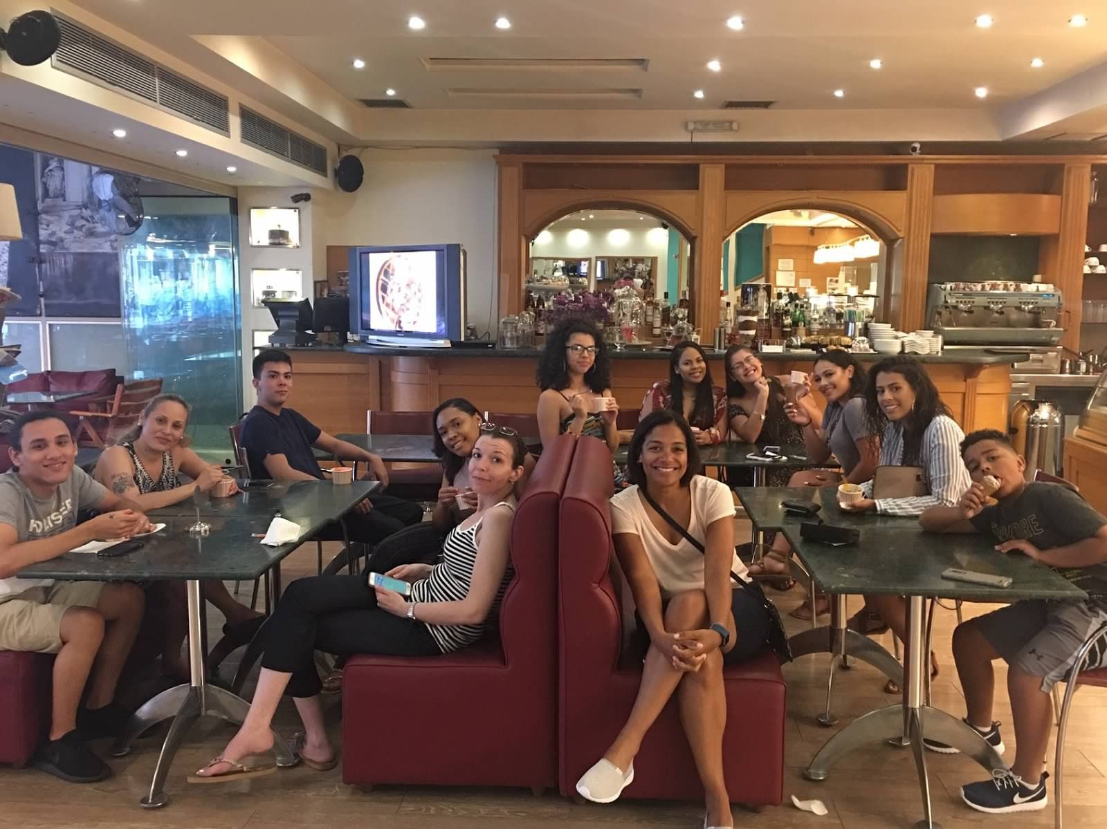 group of students in restaurant booths smile at camera