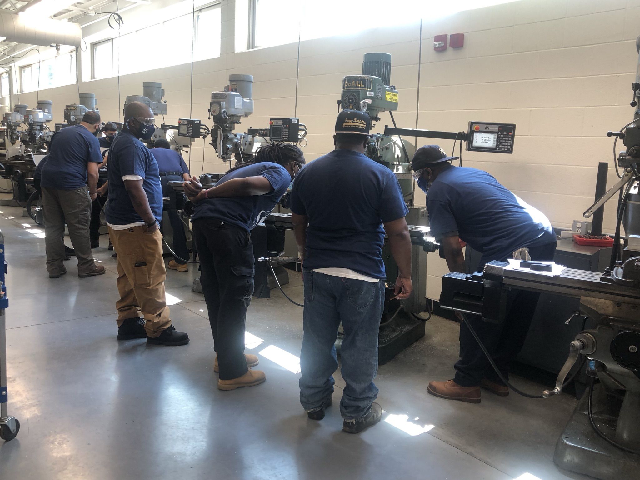 men in manufacturing lab look at machines