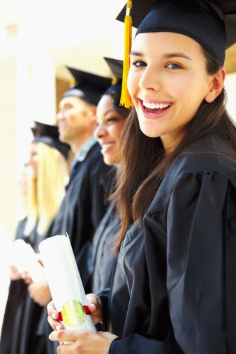 row of graduates with closest girl smiling at camera