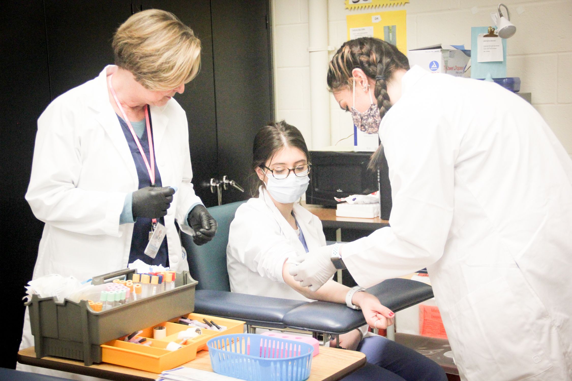 phlebotomy students practice on one another