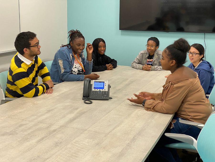 group of students around table