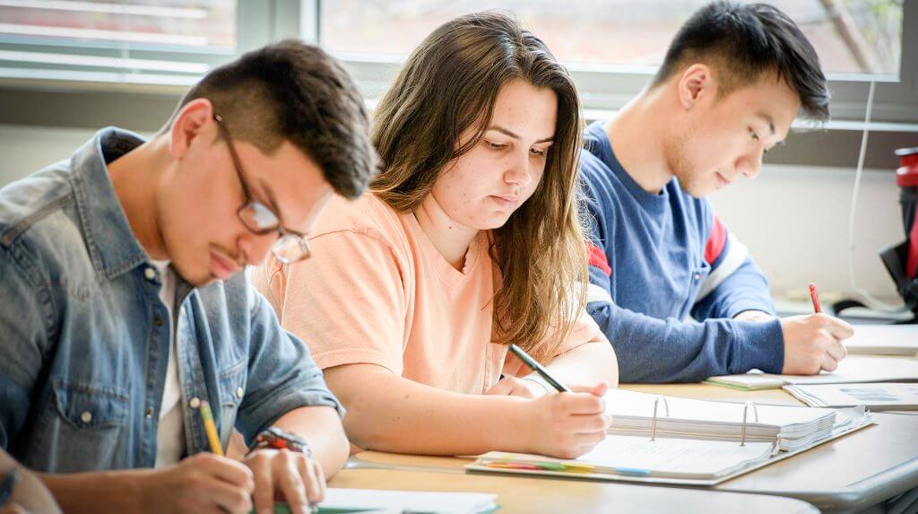Students writing in notebooks