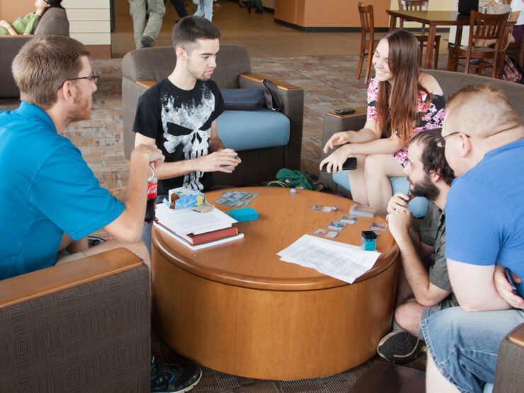 group of students play game at table